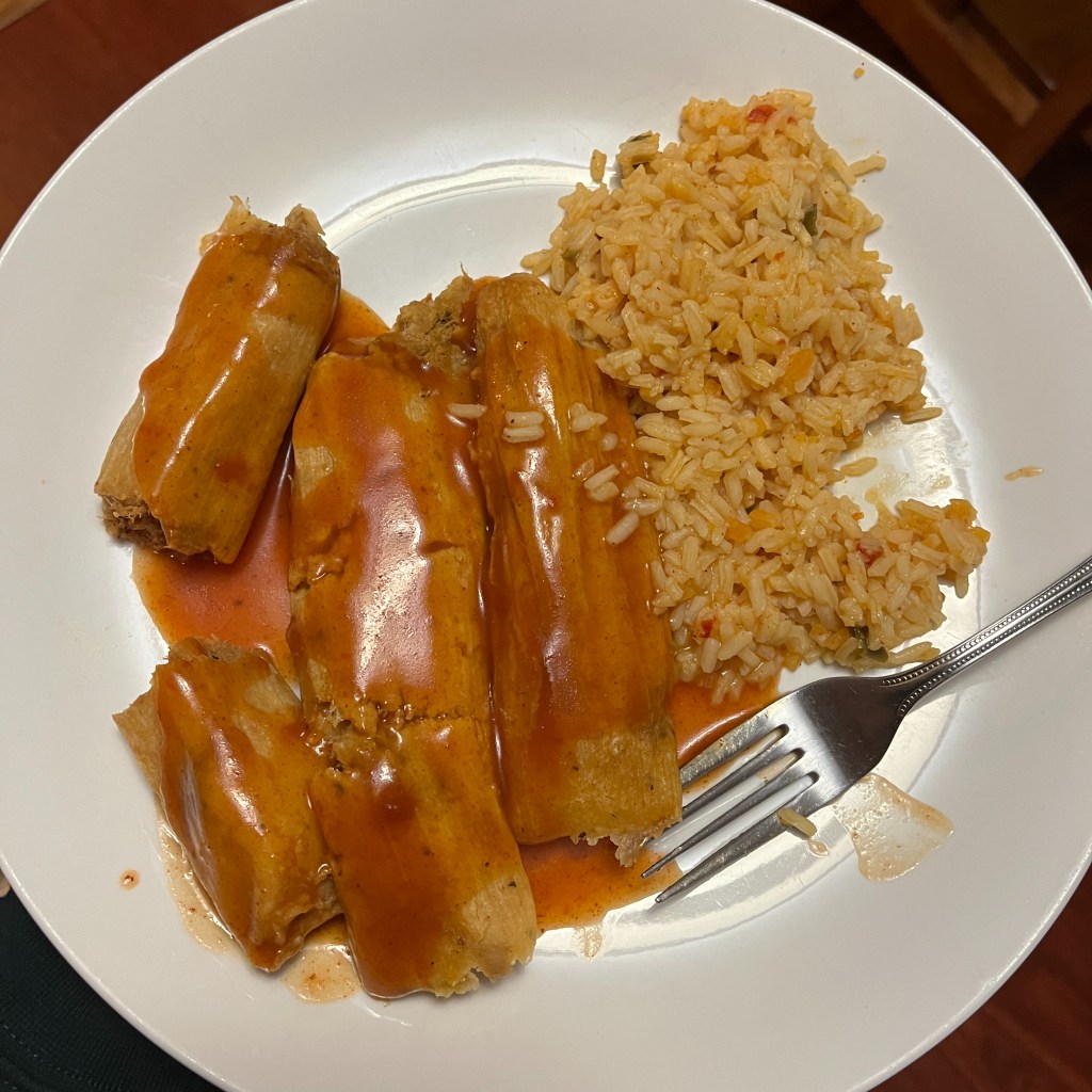 three pork tamales with "spanish" style rice